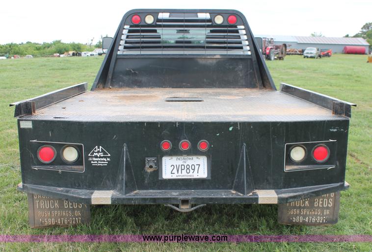 image for item K8913 2014 Dodge Ram 3500HD Quad Cab flatbed pickup truck