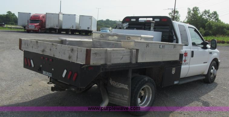 image for item L2796 1999 Ford F350 Super Duty SuperCab flatbed pickup truck