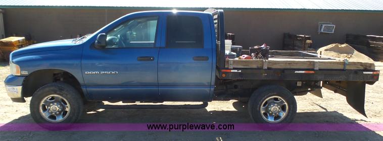 image for item J6042 2004 Dodge Ram 2500 Quad Cab flatbed pickup truck