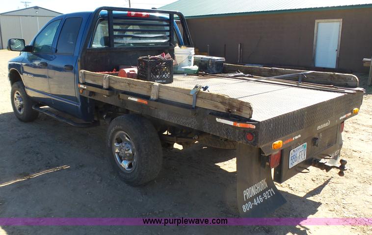image for item J6042 2004 Dodge Ram 2500 Quad Cab flatbed pickup truck