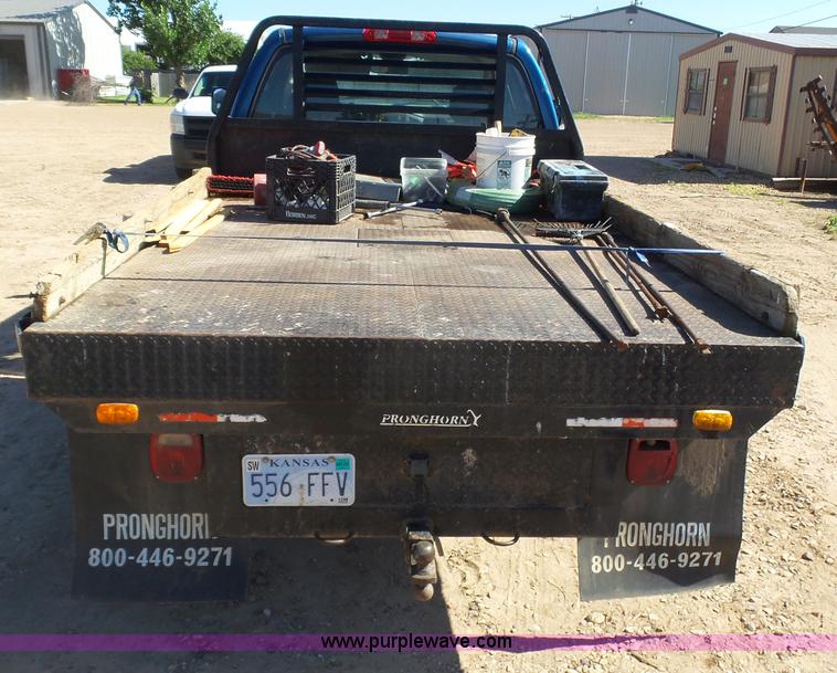 image for item J6042 2004 Dodge Ram 2500 Quad Cab flatbed pickup truck