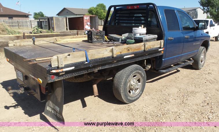 image for item J6042 2004 Dodge Ram 2500 Quad Cab flatbed pickup truck