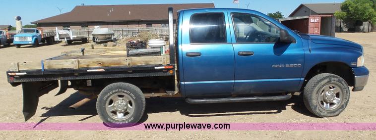 image for item J6042 2004 Dodge Ram 2500 Quad Cab flatbed pickup truck