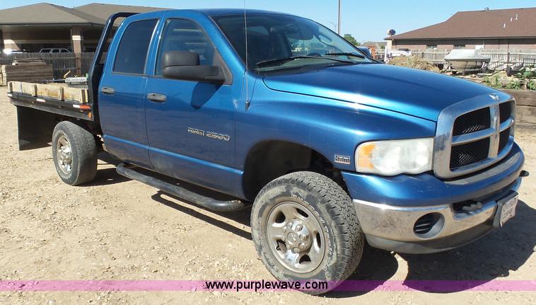 image for item J6042 2004 Dodge Ram 2500 Quad Cab flatbed pickup truck
