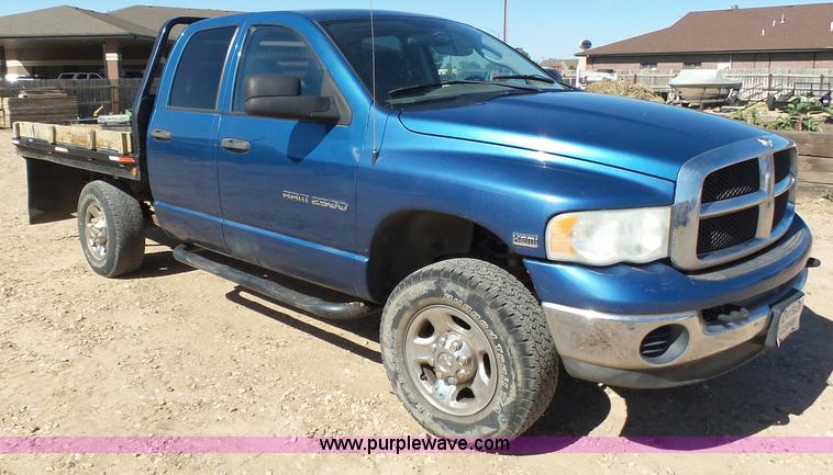 image for item J6042 2004 Dodge Ram 2500 Quad Cab flatbed pickup truck