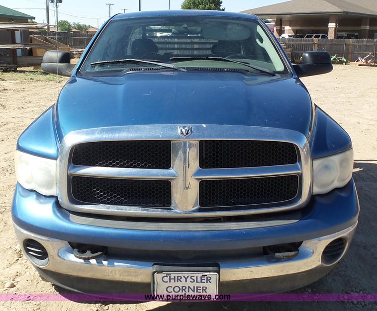 image for item J6042 2004 Dodge Ram 2500 Quad Cab flatbed pickup truck