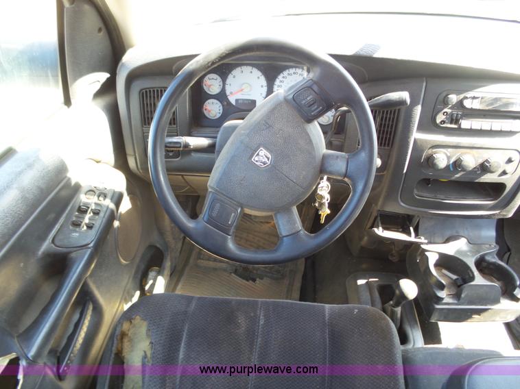 image for item J6042 2004 Dodge Ram 2500 Quad Cab flatbed pickup truck