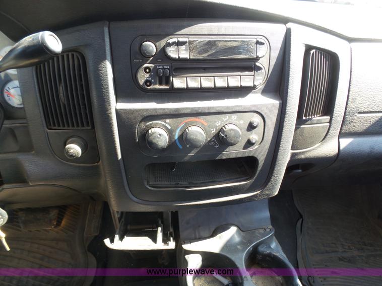 image for item J6042 2004 Dodge Ram 2500 Quad Cab flatbed pickup truck