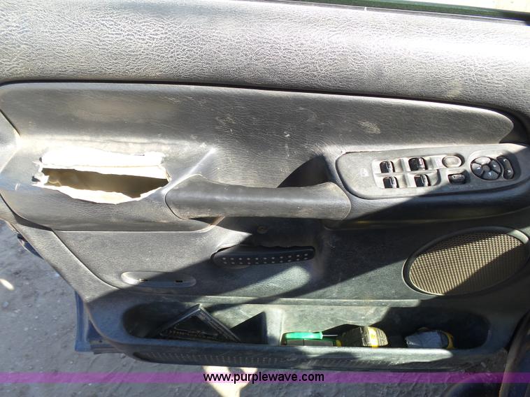 image for item J6042 2004 Dodge Ram 2500 Quad Cab flatbed pickup truck