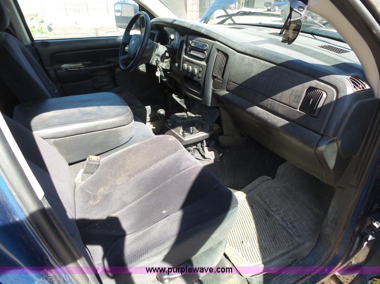 image for item J6042 2004 Dodge Ram 2500 Quad Cab flatbed pickup truck