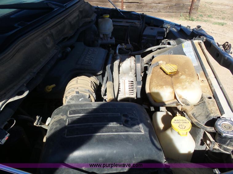 image for item J6042 2004 Dodge Ram 2500 Quad Cab flatbed pickup truck