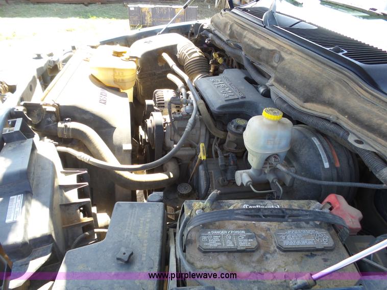 image for item J6042 2004 Dodge Ram 2500 Quad Cab flatbed pickup truck