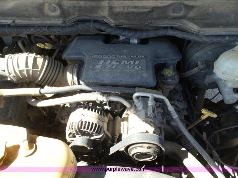 image for item J6042 2004 Dodge Ram 2500 Quad Cab flatbed pickup truck