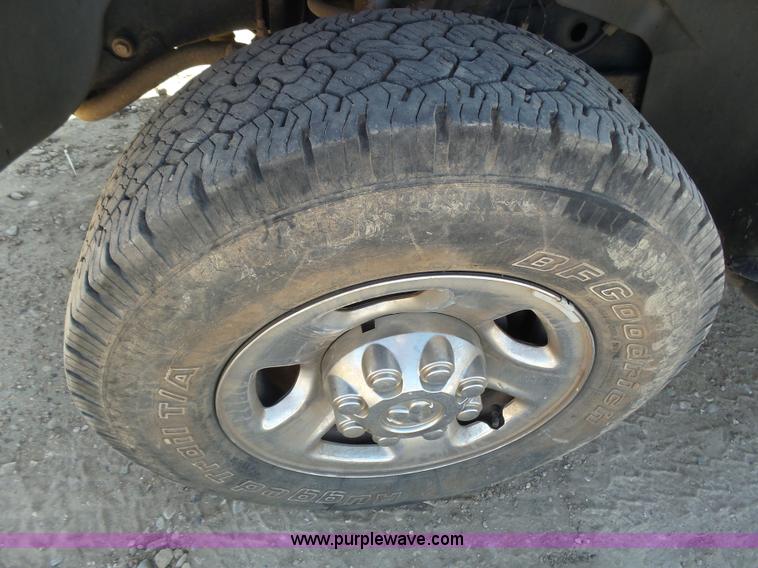 image for item J6042 2004 Dodge Ram 2500 Quad Cab flatbed pickup truck