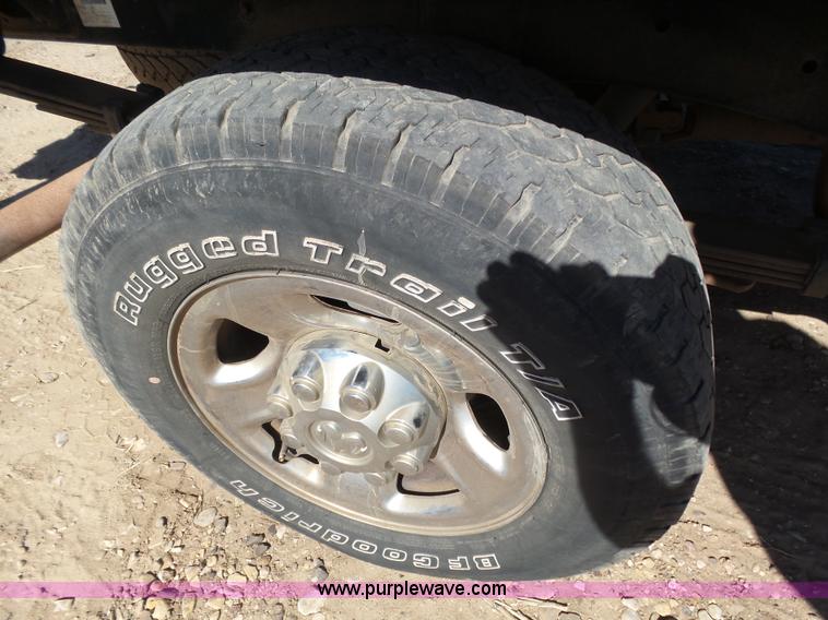 image for item J6042 2004 Dodge Ram 2500 Quad Cab flatbed pickup truck