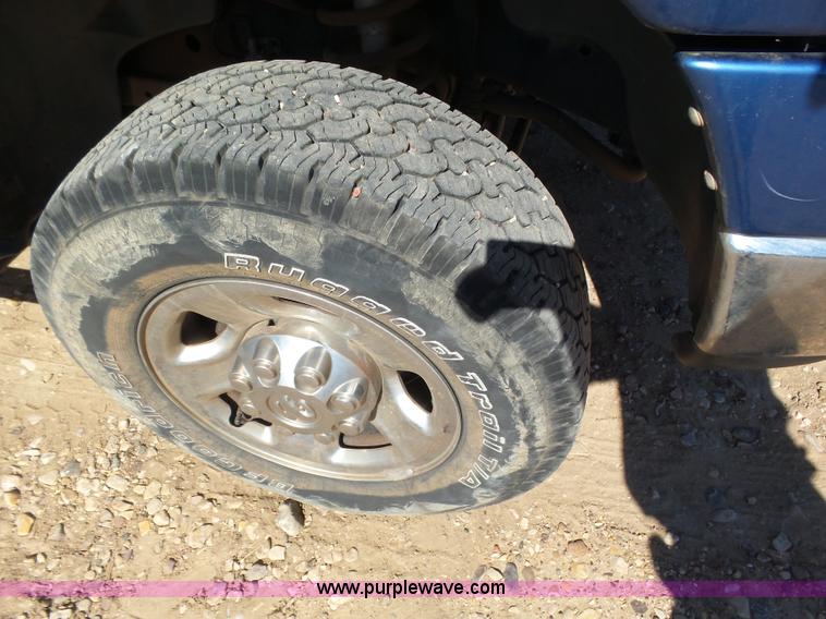 image for item J6042 2004 Dodge Ram 2500 Quad Cab flatbed pickup truck