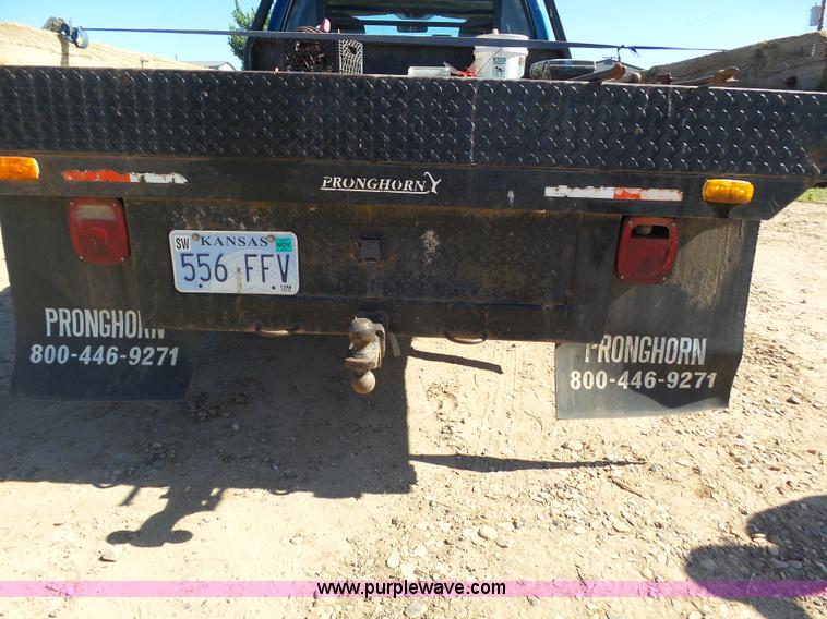 image for item J6042 2004 Dodge Ram 2500 Quad Cab flatbed pickup truck