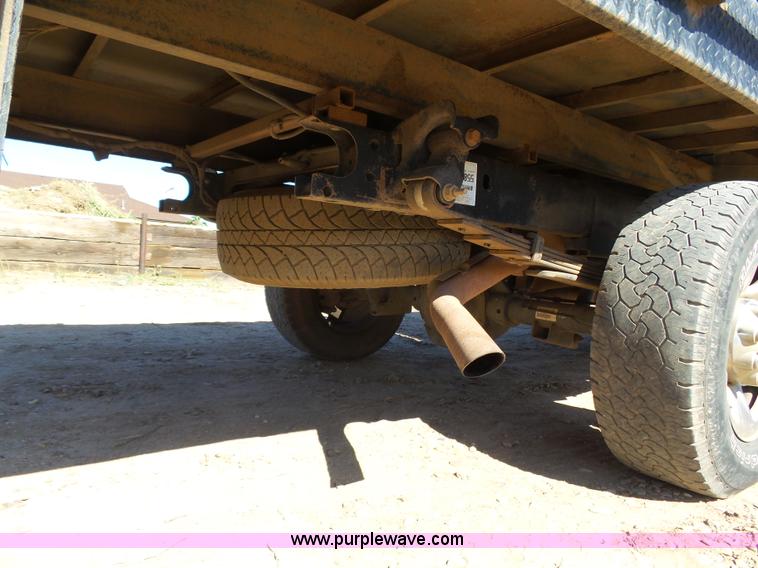 image for item J6042 2004 Dodge Ram 2500 Quad Cab flatbed pickup truck