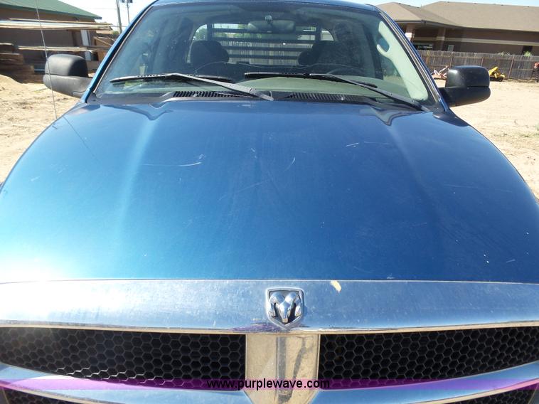 image for item J6042 2004 Dodge Ram 2500 Quad Cab flatbed pickup truck