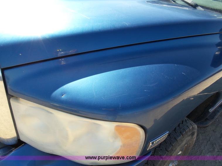 image for item J6042 2004 Dodge Ram 2500 Quad Cab flatbed pickup truck