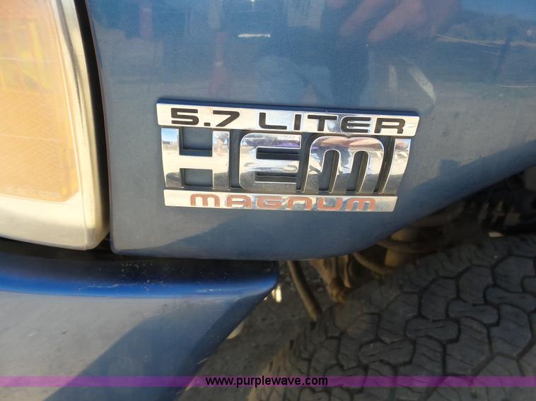 image for item J6042 2004 Dodge Ram 2500 Quad Cab flatbed pickup truck