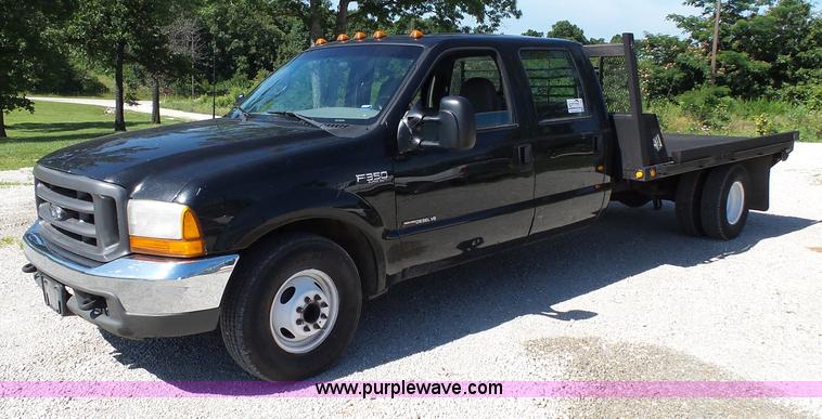 image for item K1193 2000 Ford F350 Super Duty Crew Cab flatbed pickup truck