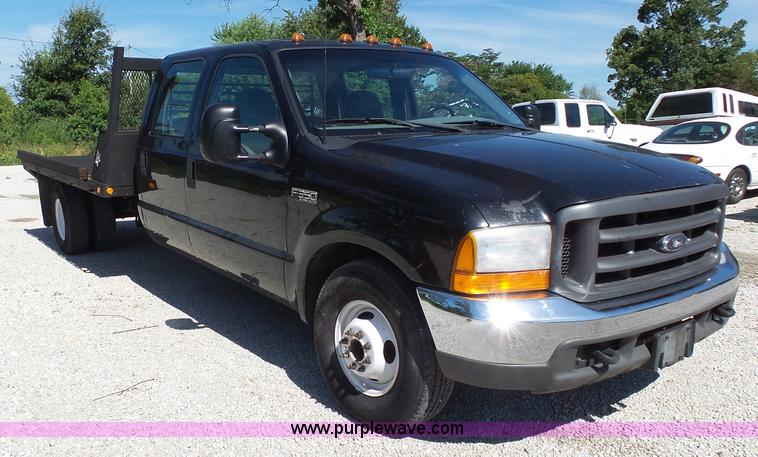 image for item K1193 2000 Ford F350 Super Duty Crew Cab flatbed pickup truck