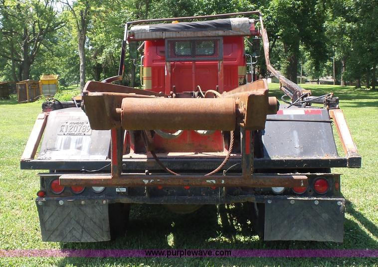 image for item K1708 1999 Volvo WG64 roll-off truck