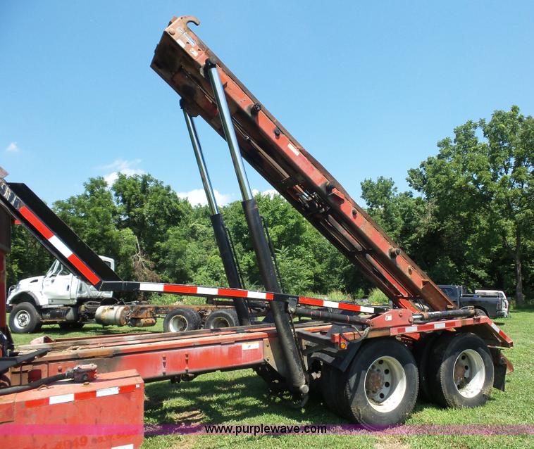 image for item K1708 1999 Volvo WG64 roll-off truck