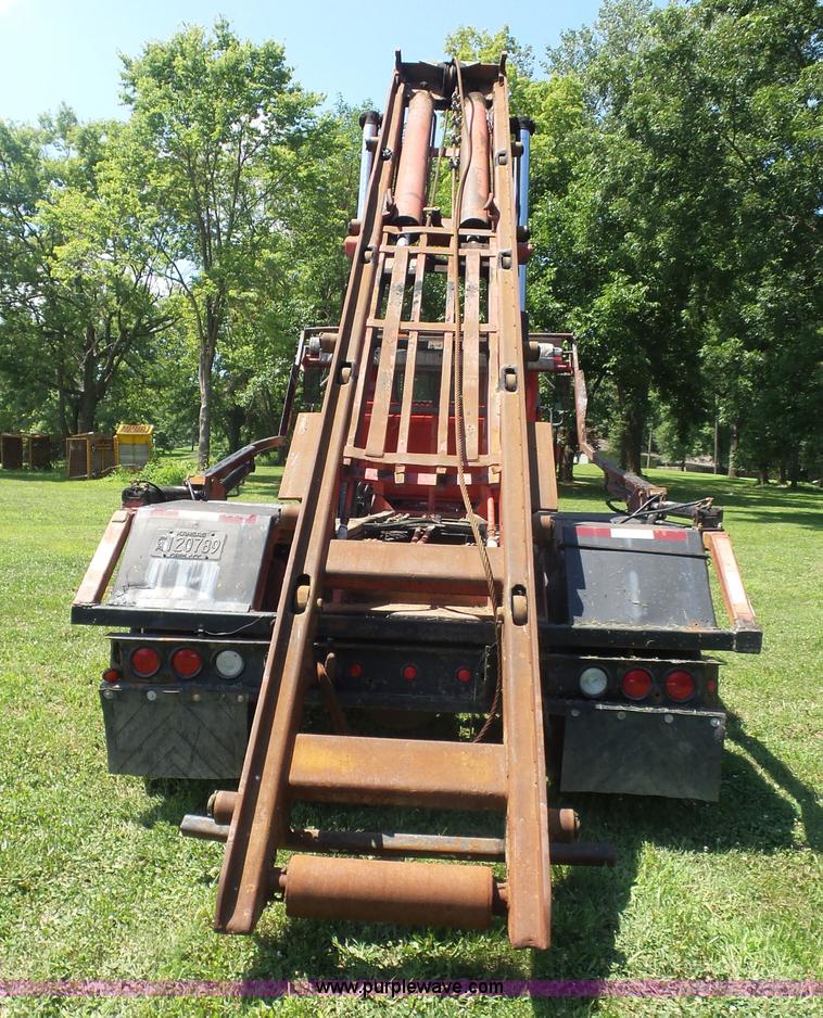 image for item K1708 1999 Volvo WG64 roll-off truck