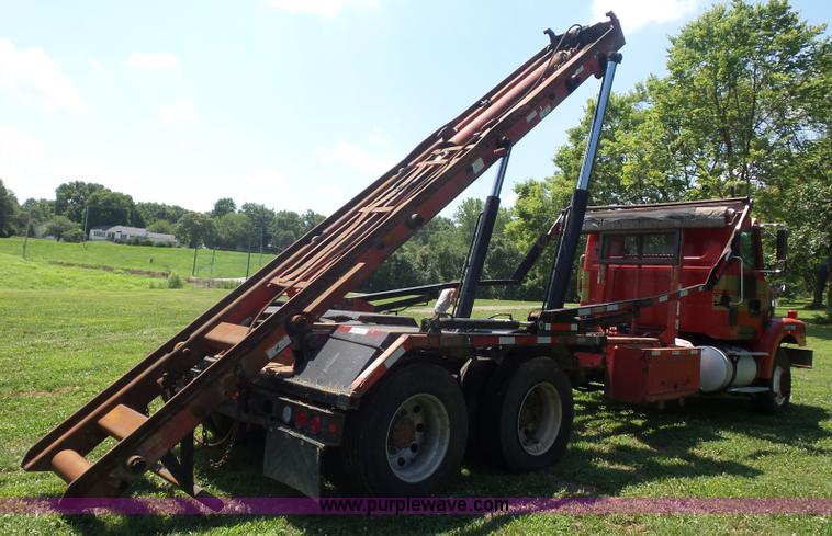 image for item K1708 1999 Volvo WG64 roll-off truck