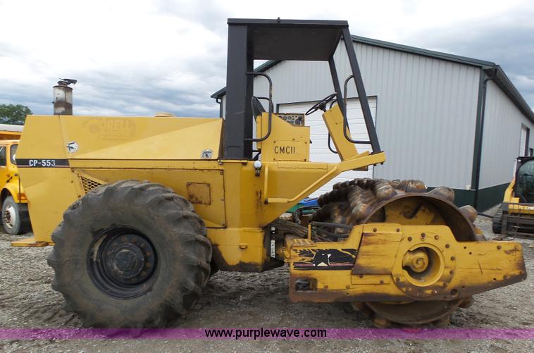 image for item K8446 1988 Caterpillar CP553 single drum pad foot compactor