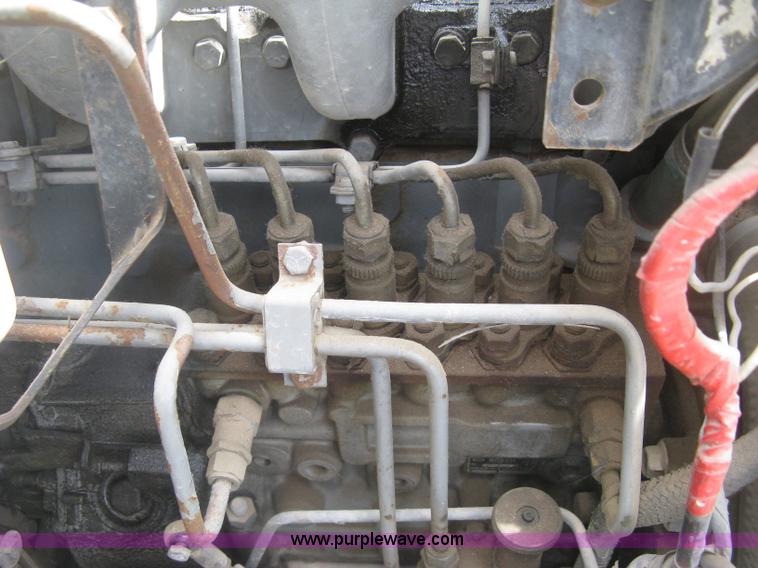 image for item J2755 1989 Ford F700F flatbed truck with crane