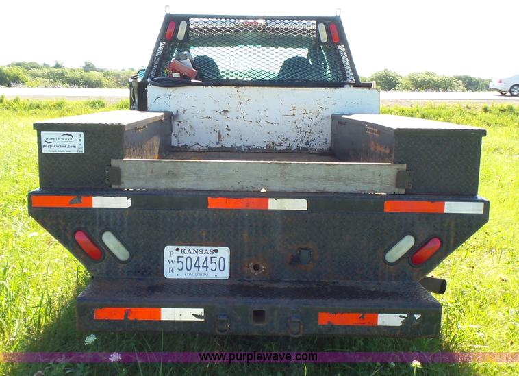 image for item K3154 2006 Ford F250 Super Duty SuperCab flatbed pickup truck