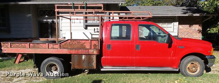 image for item L3274 1999 Ford F350 Super Duty Crew Cab flatbed pickup truck