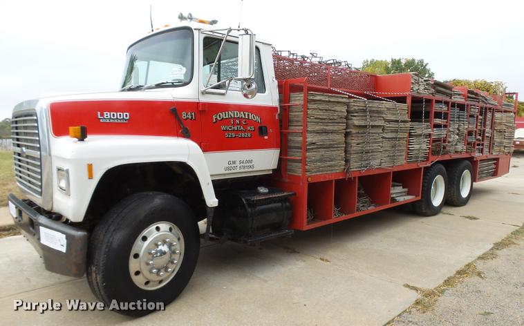 image for item L3284 1992 Ford LNT8000 flatbed truck with concrete forms