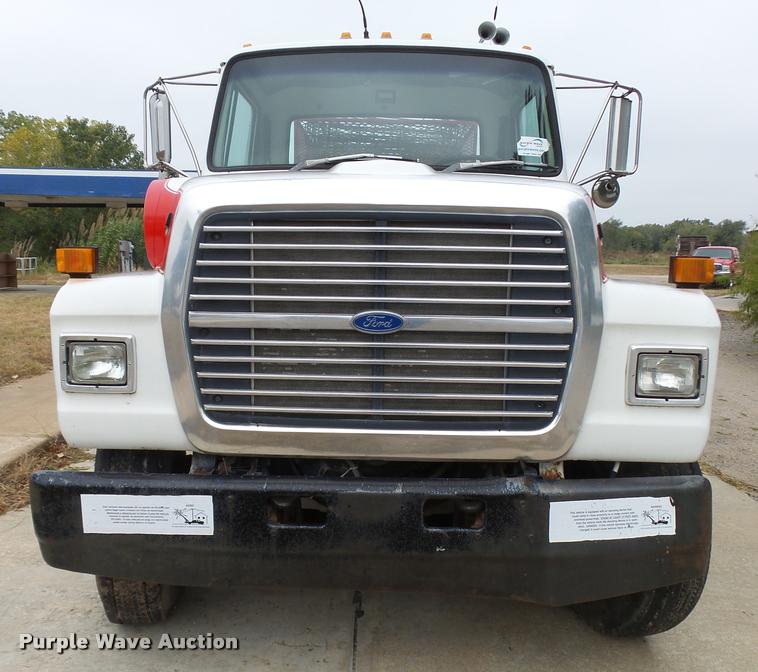 image for item L3284 1992 Ford LNT8000 flatbed truck with concrete forms