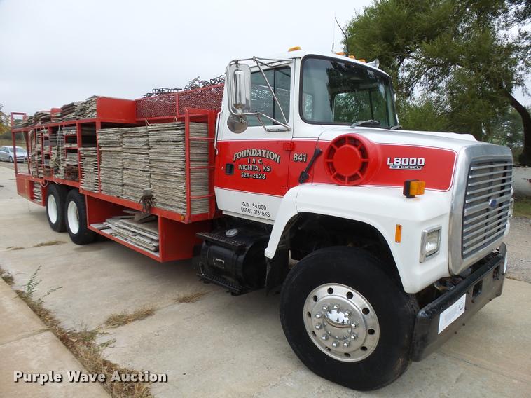 image for item L3284 1992 Ford LNT8000 flatbed truck with concrete forms