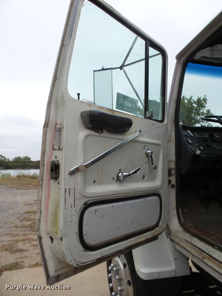 image for item L3284 1992 Ford LNT8000 flatbed truck with concrete forms