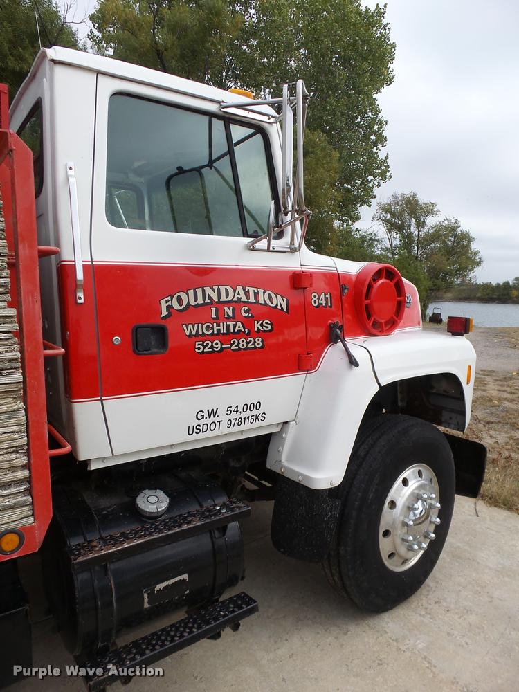 image for item L3284 1992 Ford LNT8000 flatbed truck with concrete forms