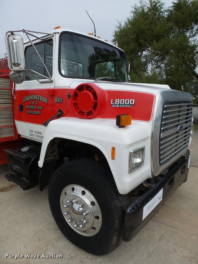 image for item L3284 1992 Ford LNT8000 flatbed truck with concrete forms