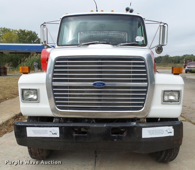image for item L3284 1992 Ford LNT8000 flatbed truck with concrete forms