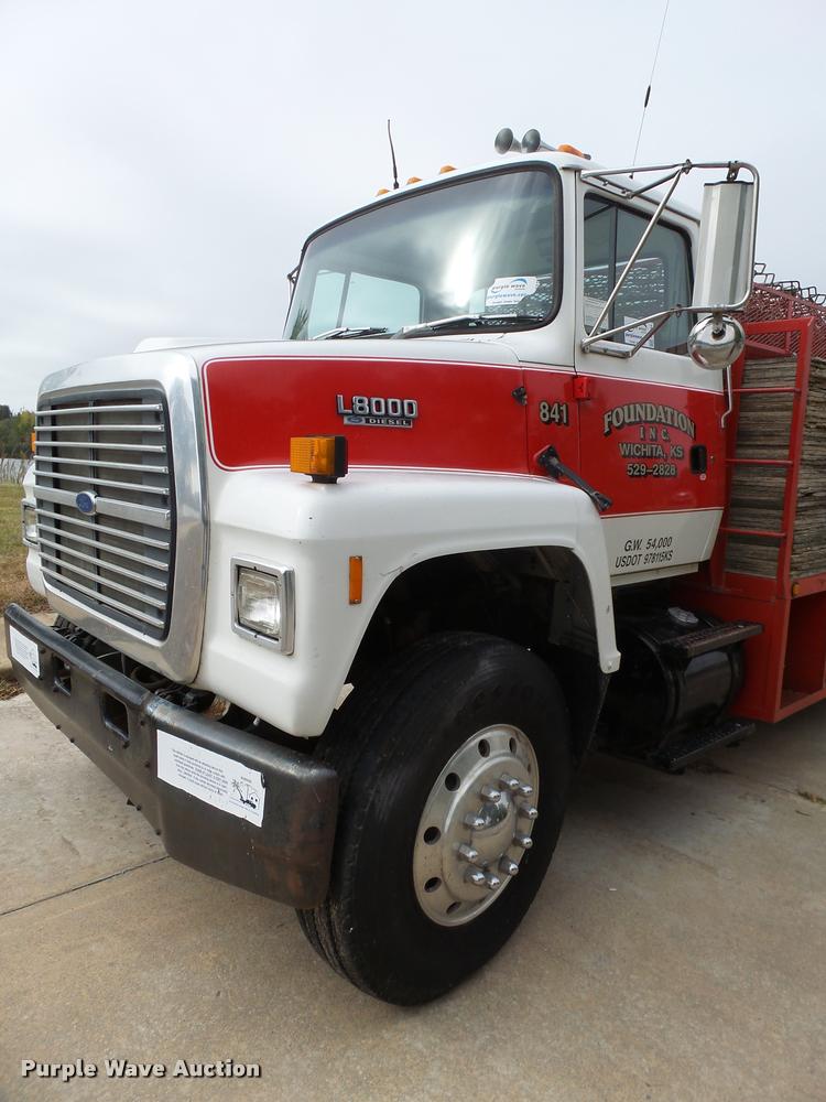 image for item L3284 1992 Ford LNT8000 flatbed truck with concrete forms