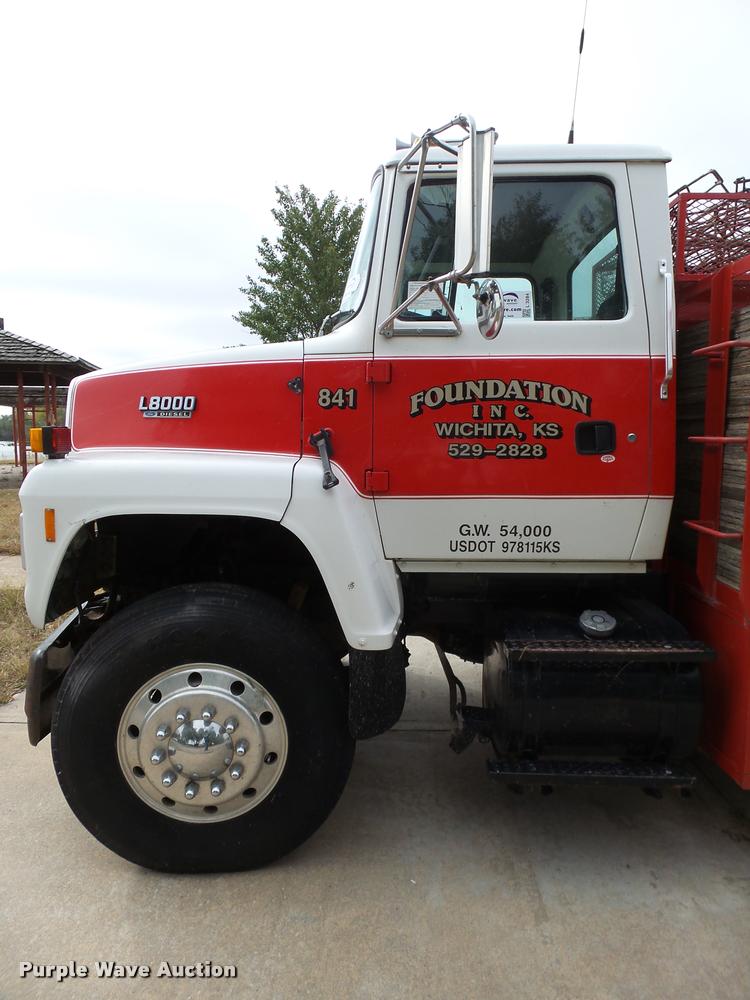 image for item L3284 1992 Ford LNT8000 flatbed truck with concrete forms