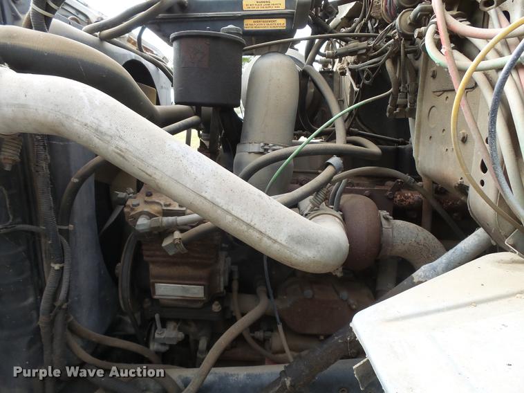 image for item L3284 1992 Ford LNT8000 flatbed truck with concrete forms