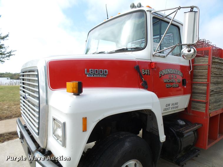 image for item L3284 1992 Ford LNT8000 flatbed truck with concrete forms