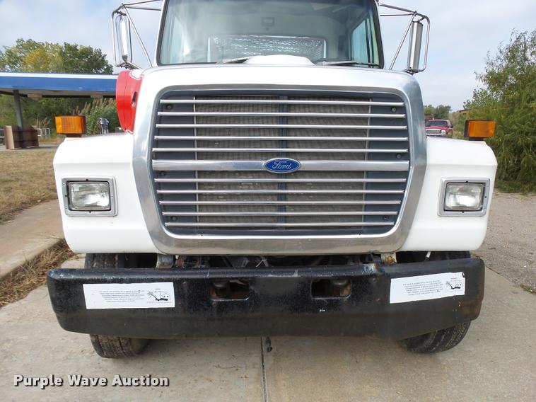 image for item L3284 1992 Ford LNT8000 flatbed truck with concrete forms