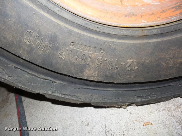 image for item AX9077 (4) skid steer tires and wheels
