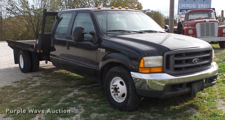 image for item K1055 2000 Ford F350 Super Duty Crew Cab flatbed pickup truck