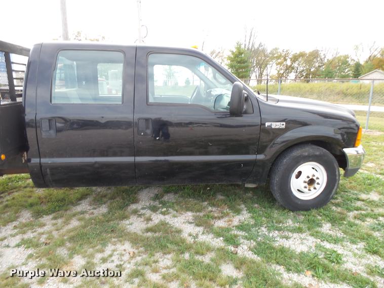 image for item K1055 2000 Ford F350 Super Duty Crew Cab flatbed pickup truck